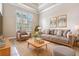Comfortable living room with neutral tones, large window, stylish furniture, and hardwood flooring at 3656 Kalanchoe Pl, Wesley Chapel, FL 33544