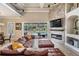 Bright living room featuring vaulted ceilings, a stacked stone fireplace, and sliding glass doors to the pool area at 3656 Kalanchoe Pl, Wesley Chapel, FL 33544