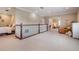 Open loft area with bedrooms and seating area with plenty of natural light at 3656 Kalanchoe Pl, Wesley Chapel, FL 33544
