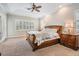Spacious main bedroom with tray ceiling, plantation shutters, and a ceiling fan at 3656 Kalanchoe Pl, Wesley Chapel, FL 33544