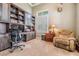 Home office boasts custom built-ins, a large window with shutters, and a comfortable recliner at 3656 Kalanchoe Pl, Wesley Chapel, FL 33544