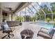 Spacious screened patio with comfortable seating, stylish decor, and a view of the pool at 3656 Kalanchoe Pl, Wesley Chapel, FL 33544