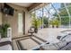 Screened patio with comfortable seating, views of the pool, and a door to the interior at 3656 Kalanchoe Pl, Wesley Chapel, FL 33544