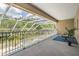 Enjoy this covered patio with a lovely pool view, enhanced by outdoor string lights and elegant outdoor furniture at 3656 Kalanchoe Pl, Wesley Chapel, FL 33544