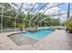 Backyard pool with water features, mature plants, and an enclosed screened enclosure at 3656 Kalanchoe Pl, Wesley Chapel, FL 33544