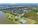 Picturesque aerial view of residential neighborhood, highlighting the community park, tennis courts, and lake at 3834 102Nd N Pl, Clearwater, FL 33762