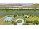 Overhead shot of community park with tennis courts and gazebo by a tranquil waterfront at 3834 102Nd N Pl, Clearwater, FL 33762