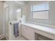 Updated bathroom features shower, built-in vanity, and a bright window at 3834 102Nd N Pl, Clearwater, FL 33762