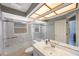 Bright bathroom featuring shower-tub combo, contemporary fixtures, and ample counter space at 3834 102Nd N Pl, Clearwater, FL 33762