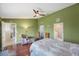 Bright bedroom boasts en suite bath, walk-in closet, ceiling fan, and hardwood floors at 3834 102Nd N Pl, Clearwater, FL 33762