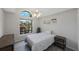 This bedroom features a ceiling fan, window, and hardwood floors at 3834 102Nd N Pl, Clearwater, FL 33762