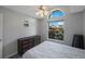 This bedroom features a ceiling fan, window, and hardwood floors at 3834 102Nd N Pl, Clearwater, FL 33762