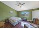 This bedroom offers a ceiling fan, window, and hardwood floors at 3834 102Nd N Pl, Clearwater, FL 33762