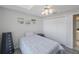 This bedroom features a ceiling fan, large closet, and white walls at 3834 102Nd N Pl, Clearwater, FL 33762