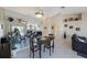 Bright dining room features tile flooring, mirror accent wall, and access to living area at 3834 102Nd N Pl, Clearwater, FL 33762