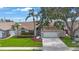 Inviting home with a manicured lawn, lush landscaping, and a spacious two-car garage at 3834 102Nd N Pl, Clearwater, FL 33762