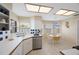 Bright eat-in kitchen with white cabinetry, tile backsplash, stainless appliances, and breakfast table at 3834 102Nd N Pl, Clearwater, FL 33762