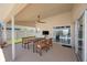 Enjoy this screened lanai with ceiling fan, dining table and chairs, and TV for ultimate outdoor entertaining at 3834 102Nd N Pl, Clearwater, FL 33762