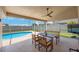 Enjoy outdoor dining on the covered lanai, overlooking the sparkling pool and lush backyard at 3834 102Nd N Pl, Clearwater, FL 33762
