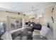 Bright living room features vaulted ceilings, neutral walls, tile floors, and slider to the patio at 3834 102Nd N Pl, Clearwater, FL 33762