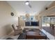 Open concept living area features tile floors, fireplace, and slider to screened patio at 3834 102Nd N Pl, Clearwater, FL 33762
