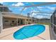 Private pool surrounded by a screened enclosure, offering a serene backyard retreat at 3834 102Nd N Pl, Clearwater, FL 33762