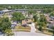 An aerial view showcases this well-maintained single Gathering home with a private driveway and mature trees at 3968 Orchard Hill Cir, Palm Harbor, FL 34684