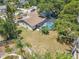 Aerial view of the home showcasing the backyard, pool, and surrounding landscape at 3968 Orchard Hill Cir, Palm Harbor, FL 34684