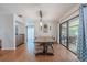 Elegant dining room featuring hardwood floors, contemporary lighting, and sliding glass doors at 3968 Orchard Hill Cir, Palm Harbor, FL 34684