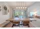 Dining room featuring a wooden table, bench seating, and a view of screened-in pool at 3968 Orchard Hill Cir, Palm Harbor, FL 34684