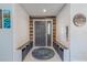 Welcoming entryway featuring built-in seating, stylish accents, and neutral decor at 3968 Orchard Hill Cir, Palm Harbor, FL 34684