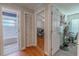 Hallway view of full bathroom and bedroom with hardwood floors at 3968 Orchard Hill Cir, Palm Harbor, FL 34684
