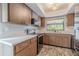 Bright kitchen with wood cabinets, modern appliances, ample counter space, and a decorative light fixture at 3968 Orchard Hill Cir, Palm Harbor, FL 34684