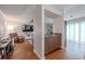 Open-concept living room featuring wood floors, bar area, and comfortable leather seating at 3968 Orchard Hill Cir, Palm Harbor, FL 34684