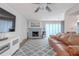 Living room with wood floors, a brick fireplace, comfortable seating, and a ceiling fan at 3968 Orchard Hill Cir, Palm Harbor, FL 34684