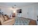 Living room featuring wood floors, plush furniture, a television, and a ceiling fan at 3968 Orchard Hill Cir, Palm Harbor, FL 34684