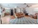 Spacious living room blending into the kitchen, featuring comfortable seating and wood floors at 3968 Orchard Hill Cir, Palm Harbor, FL 34684