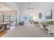 Spacious living room with vaulted ceilings, modern decor, and access to the patio at 3968 Orchard Hill Cir, Palm Harbor, FL 34684