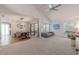 Open-concept living room connecting dining area, featuring large windows, and modern style at 3968 Orchard Hill Cir, Palm Harbor, FL 34684