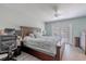 Spacious main bedroom with a ceiling fan and sliding door to backyard at 3968 Orchard Hill Cir, Palm Harbor, FL 34684