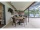 Covered patio with a dining table and seating, perfect for enjoying outdoor meals at 3968 Orchard Hill Cir, Palm Harbor, FL 34684