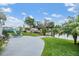 Spacious backyard with a patio, lush lawn, and waterfront views at 4041 Star Island Dr, Holiday, FL 34691