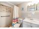 Bright bathroom featuring a single sink vanity and a shower-tub combination at 4041 Star Island Dr, Holiday, FL 34691