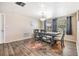 Bright dining room with wood-look floors, a modern table set, and natural light at 4041 Star Island Dr, Holiday, FL 34691