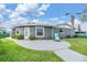 Well-maintained home featuring a curved patio, landscaped garden, and serene outdoor seating area at 4041 Star Island Dr, Holiday, FL 34691