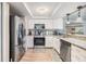 Bright kitchen features granite counters and stainless appliances at 4041 Star Island Dr, Holiday, FL 34691