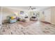 Bright living room featuring stylish furnishings, wood-look floors and a ceiling fan at 4041 Star Island Dr, Holiday, FL 34691