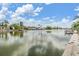 Picturesque water view showcasing the calm water, nearby houses, and beautiful cloudy skies at 4041 Star Island Dr, Holiday, FL 34691