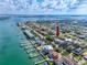 An aerial view showcases the coastal community and a home near the water with stunning views of the ocean and skyline at 405 8Th N Ave, Tierra Verde, FL 33715