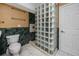 Bathroom showcases a glass block shower and a sleek toilet with convenient storage and towel racks at 405 8Th N Ave, Tierra Verde, FL 33715
